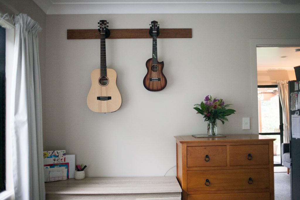 Desk with dresser and guitar and ukelele