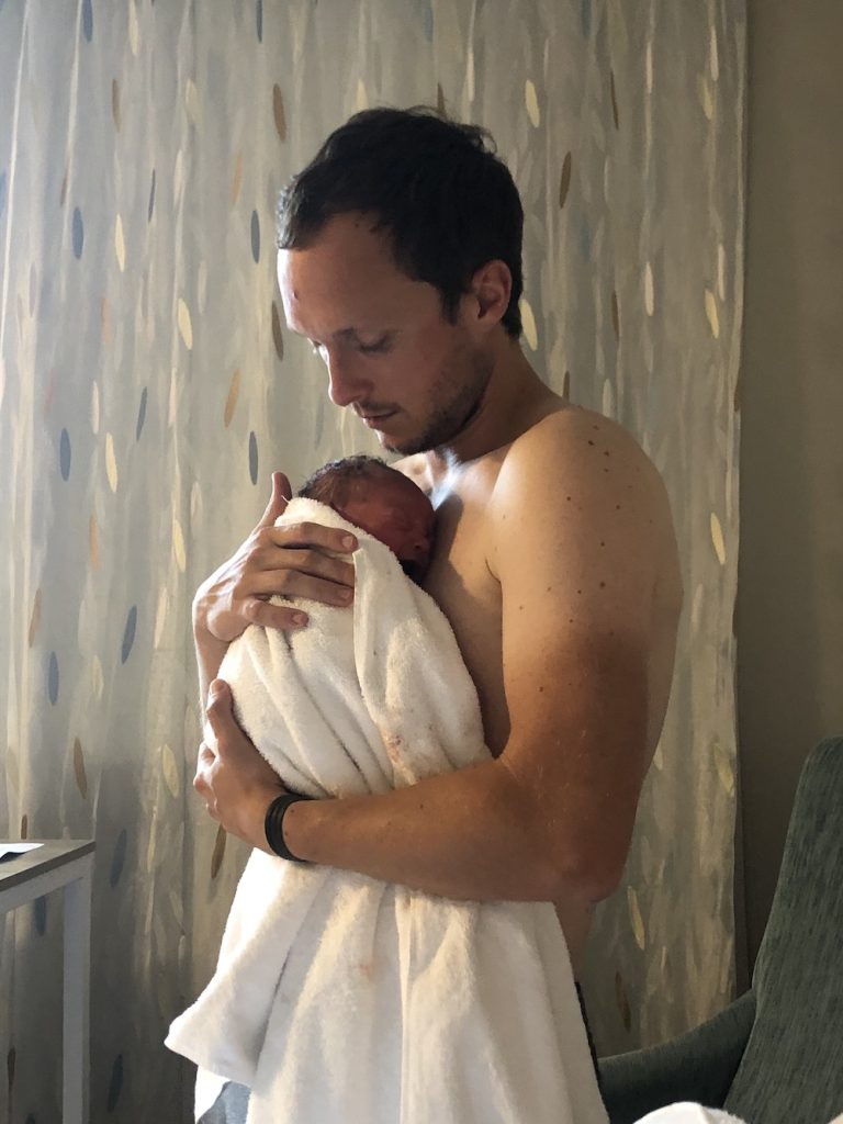 Dad holding baby after good birth