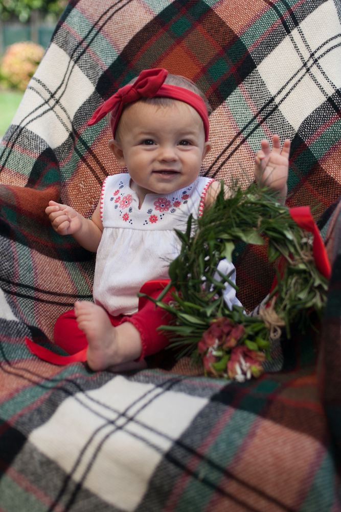 Little girl's first Christmas, holding a homemade Christmas wreath