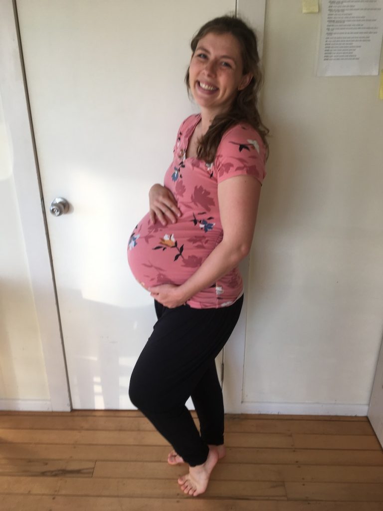Pregnant woman holding belly 40 weeks