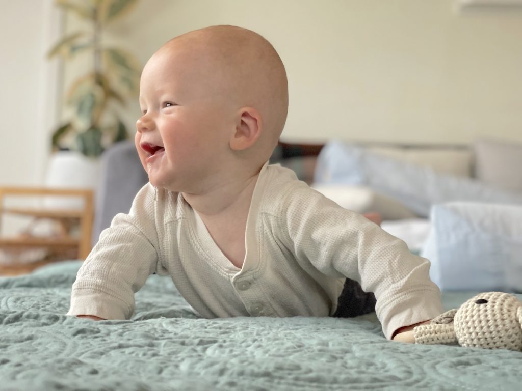 Baby on tummy pushing up and smiling