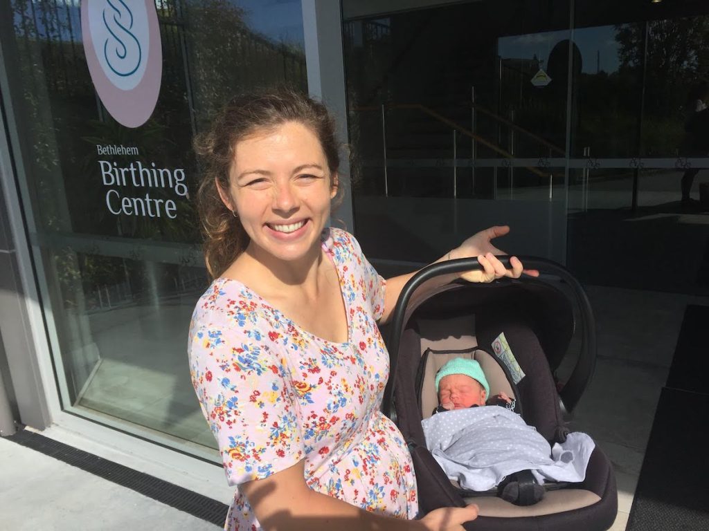 Mom carrying baby in car seat