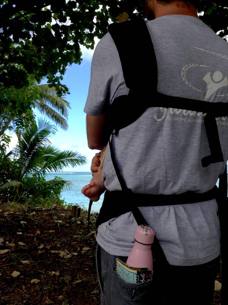 Dad holding baby in an ergo baby carrier
