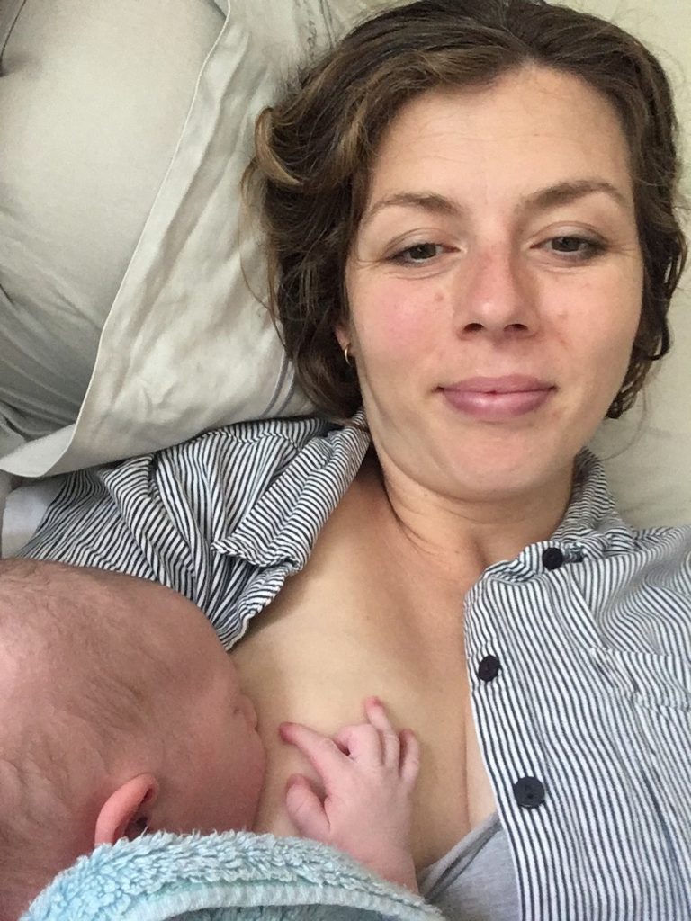 Tired mom breastfeeding baby