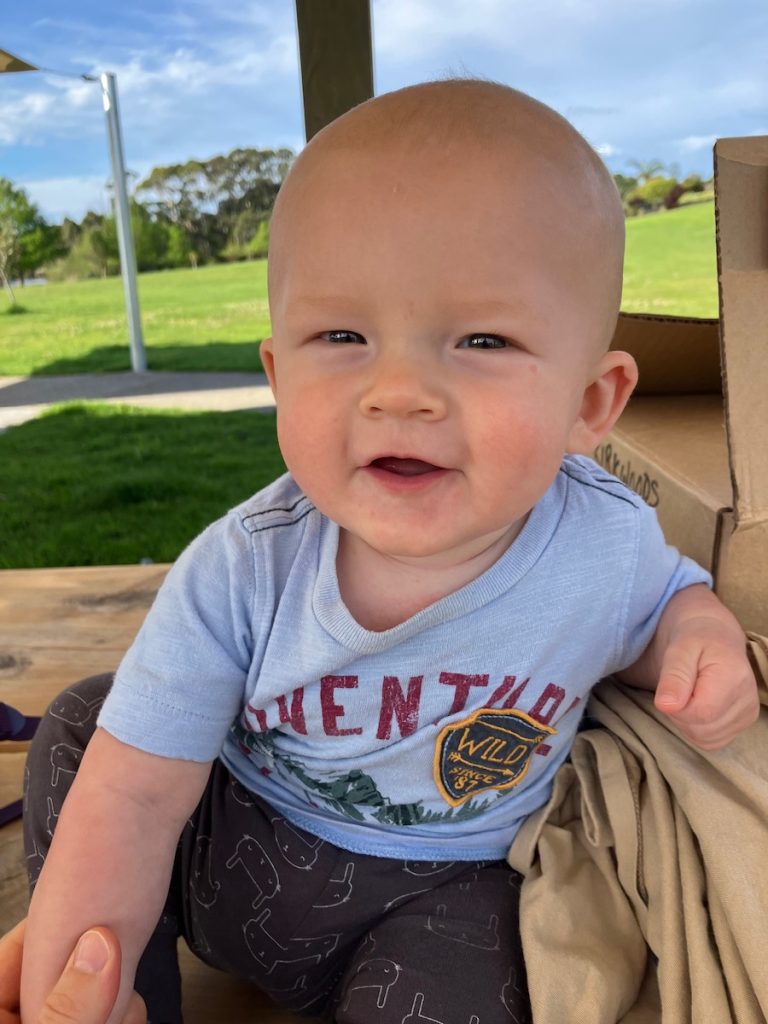 breastfed baby outside smiling