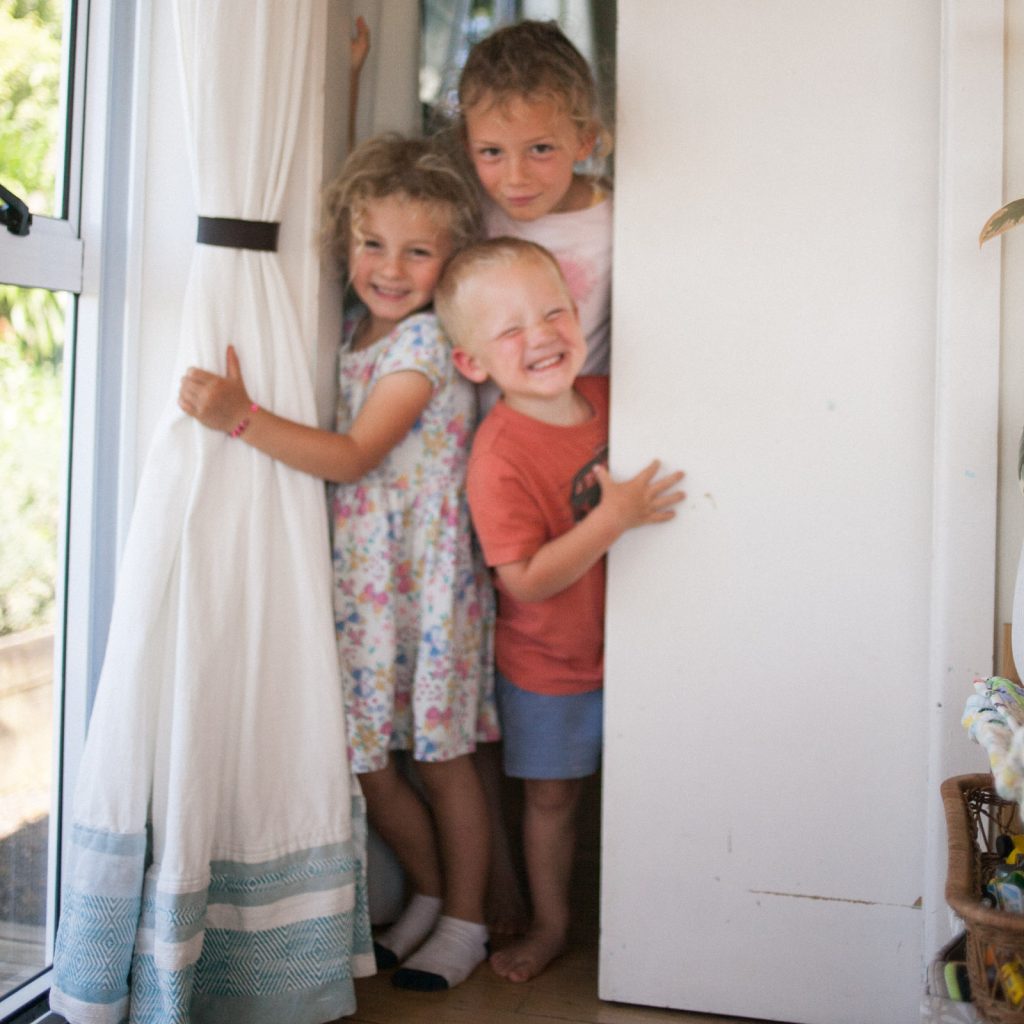 three children coming out of their shared bedroom in the morning