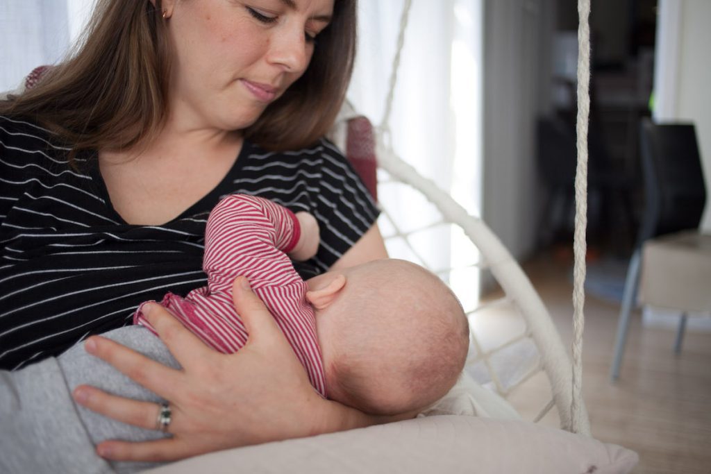 Mom breastfeeding baby cradle hold