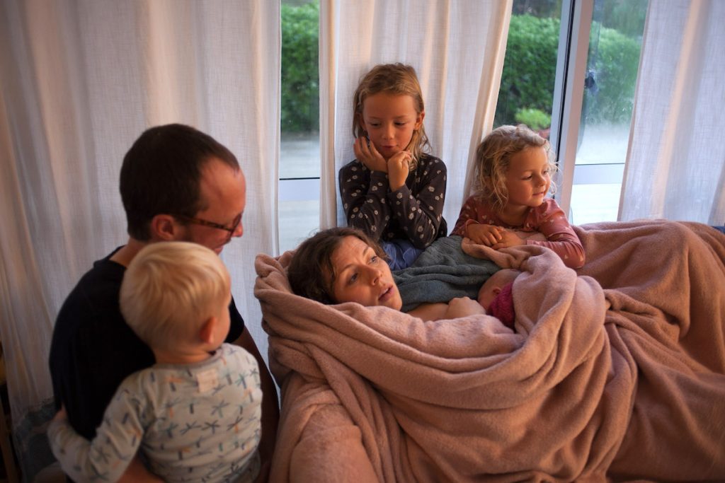mother breastfeeding wrapped in blanket