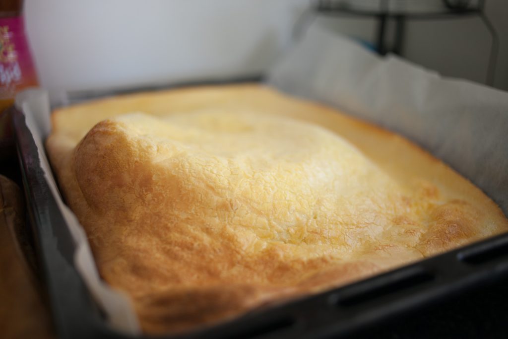 Baked and puffy golden brown sheet pan Swedish Pancakes in pan