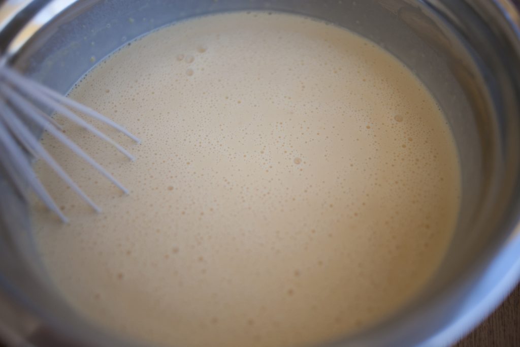 Sheet Pan Swedish pancake batter whisked smooth in bowl with whisk