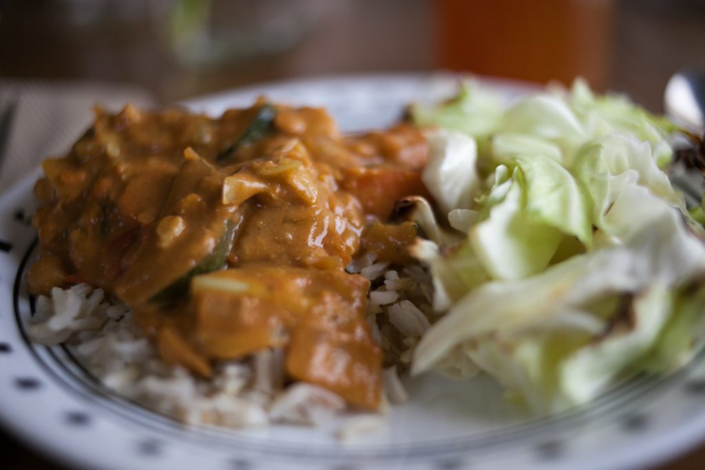 peanut butter curry on rice with roasted cabbage