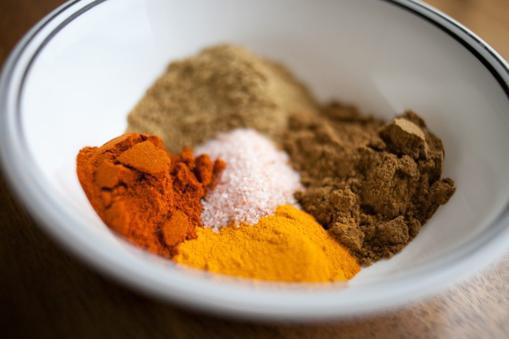 bowl with 5 bright spices piled inside