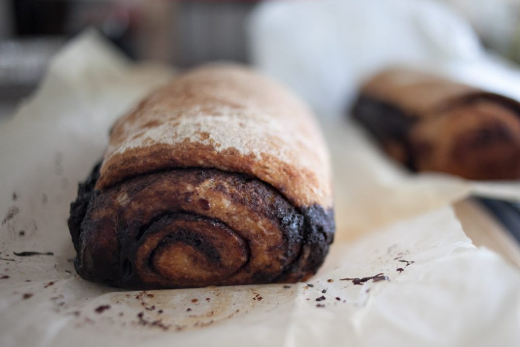 chocolate chai swirl bread loaf on cutting board in baking paper