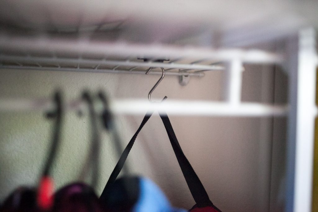 S hook being used for extra hanging storage in shared kids closet