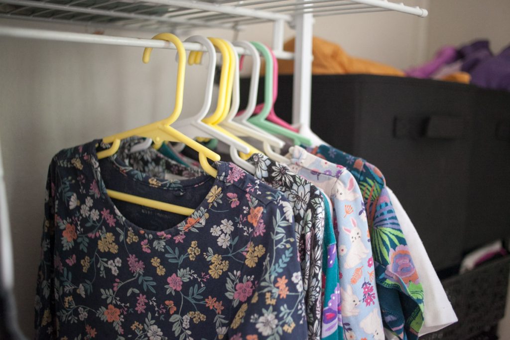 dresses hanging on low closet rod in kids closet