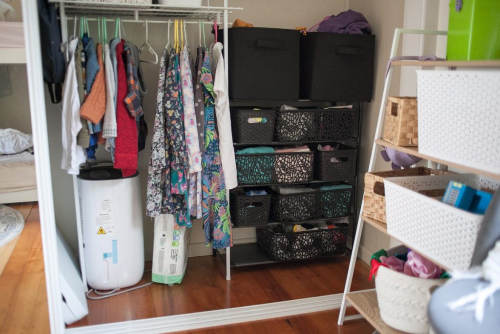 kids closet ideas for independence: childrens clothes hanging on low closet rod in shared kids closet