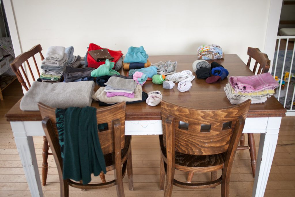 folded laundry on dining room table