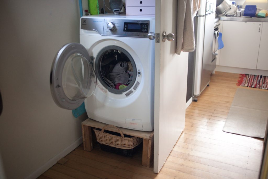 washing machine behind bathroom door